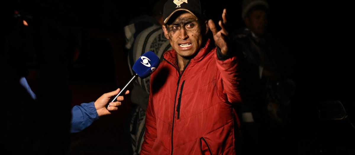 A relative of a dead miner after an explosion at a coal mine gives a statement to the media in Sutatausa, Cundinamarca department, Colombia on May 4, 2026. Nine miners died and six others were rescued following an explosion at a legal coal mine in central Colombia on May 4, 2026, according to the final tally released by authorities at the end of the search operation. (Photo by Luis ACOSTA / AFP)