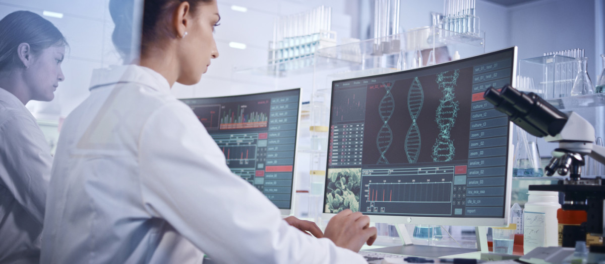 Scientists examines DNA models in modern Genetic Research Laboratory.