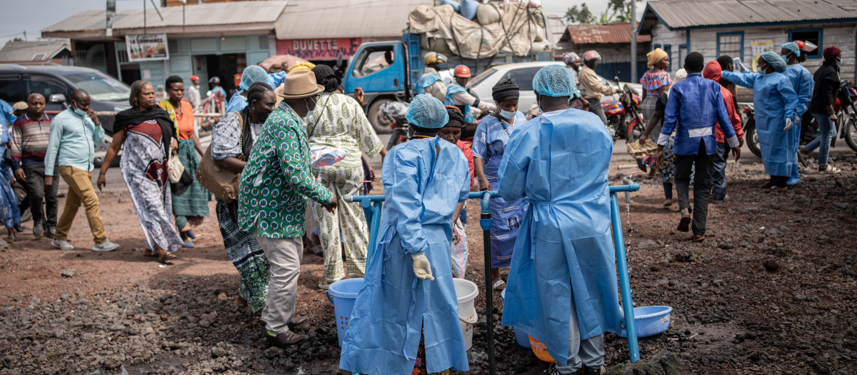 Personal sanitario con batas y mascarillas protectoras trabaja en un puesto de control habilitado como medida preventiva contra el ébola en Kanyaruchinya, cerca de Goma, Kivu del Norte, República Democrática del Congo