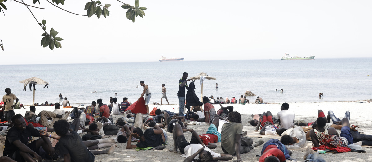 Varios migrantes en la playa, a 1 de agosto de 2026, en Ceuta (España).