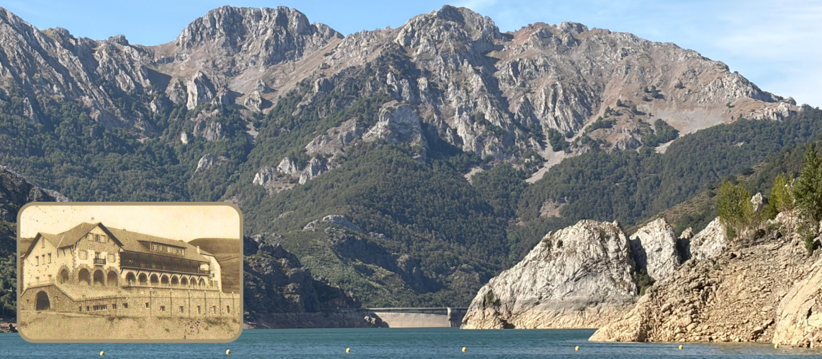 Al fondo, imagen del muro de hormigón que retiene las aguas del Esla y el parador de Riaño antes de su demolición