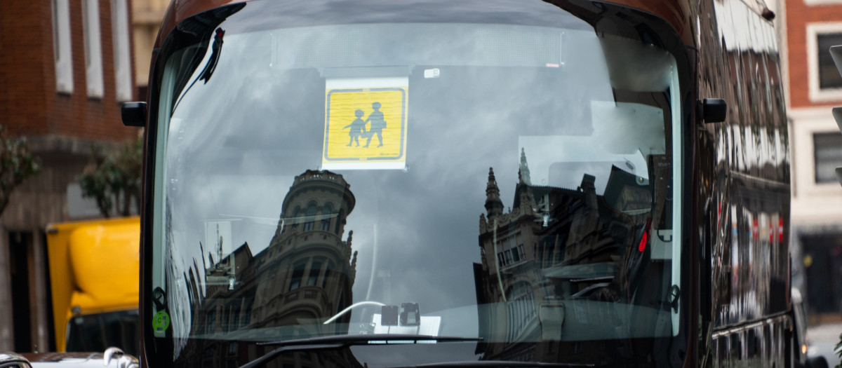 A bus with a school bus sign in its front