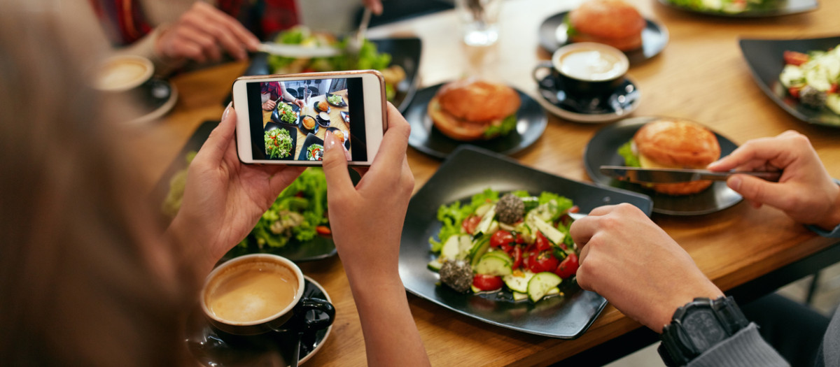 Photo On Phone. Closeup Woman Hands Photographing Food On Mobile Phone In Restaurant. High Resolution