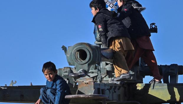Niños juegan sobre un carro de combate