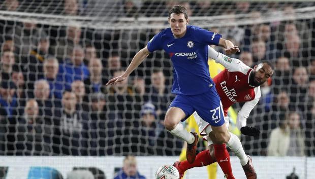 Chelsea's Andreas Christensen, left, escapes Arsenal's Alexandre Lacazette during the English League Cup semifinal, first leg, soccer match between Chelsea and Arsenal at Stamford Bridge stadium in London, Wednesday, Jan. 10, 2018. (AP Photo/Kirsty Wigglesworth)