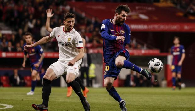 Lenglet, en su etapa de jugador del Sevilla, ante Leo Messi