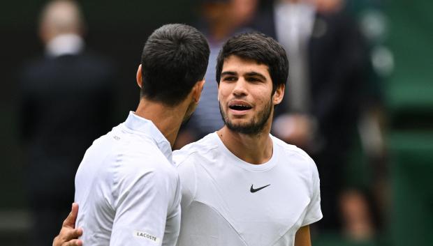 Carlos Alcaraz y Novak Djokovic se saludan antes de empezar el partido