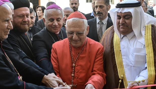 Patriarch of the Chaldean Catholic church Raphael Sako (2nd R) cuts the ribbon before a mass in the 80-year-old Chaldean Catholic Church of Um al-Mauna, "Our Lady of Perpetual Help", in Mosul in northern Iraq on April 5, 2024. With chants and joyous ululations, Iraqi Christians celebrated the restoration of the church on April 5, years after jihadists turned it into a religious police office. (Photo by Zaid AL-OBEIDI / AFP)