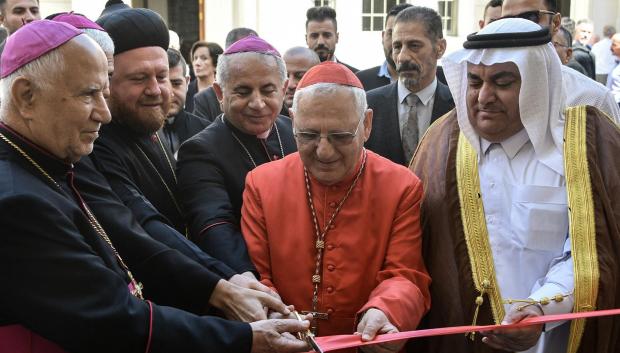 Patriarch of the Chaldean Catholic church Raphael Sako (2nd R) cuts the ribbon before a mass in the 80-year-old Chaldean Catholic Church of Um al-Mauna, "Our Lady of Perpetual Help", in Mosul in northern Iraq on April 5, 2024. With chants and joyous ululations, Iraqi Christians celebrated the restoration of the church on April 5, years after jihadists turned it into a religious police office. (Photo by Zaid AL-OBEIDI / AFP)