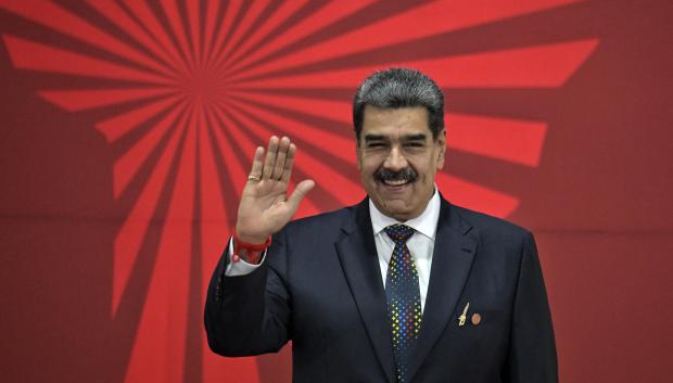 Venezuela's President Nicolas Maduro waves during the opening of the XXIV ALBA-TCP Summit in Caracas on December 14, 2024. The Bolivarian Alliance for the Peoples of Our America (ALBA) celebrates its 20th anniversary in a regional context where its influence is increasingly diminishing. The summit, originally planned in Havana where the founding document was signed, was moved to the Venezuelan capital at the peak of an economic crisis that is hitting Cuba. (Photo by JUAN BARRETO / AFP)