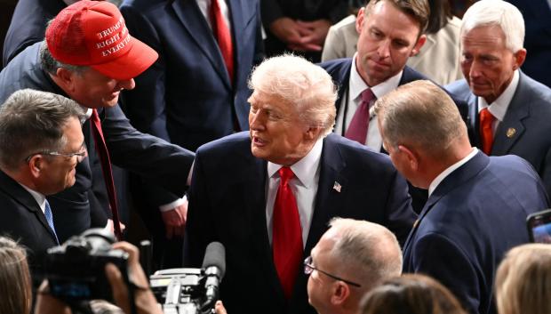 US President Donald Trump shakes hands with members of Congress as he departs following his State of the Union address in the House Chamber of the US Capitol in Washington, DC, on February 24, 2026. (Photo by ANDREW CABALLERO-REYNOLDS / AFP)