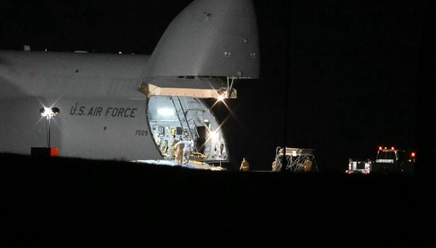 Members of the US military offload equipment from a US Air Force C-5 Galaxy at RAF Fairford in south west England on March 6, 2026. Britain's Prime Minister Keir Starmer has given approval for Washington to use the bases of Diego Garcia in the Indian Ocean and RAF Fairford in southwest England to bomb Iranian missile sites, after several Gulf countries were targeted by Iranian retaliations. (Photo by JUSTIN TALLIS / AFP)