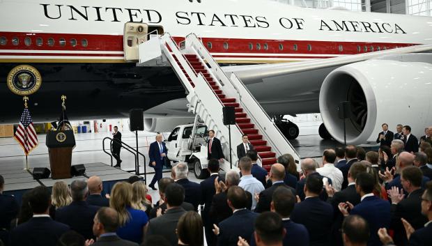 US President Donald Trump speaks in front of the new Air Force One, gifted to him by by Qatar, in a hangar at Joint Base Andrews in Maryland on June 19, 2026. White House officials bade farewell on June 18, 2026 to one of the two jets that have been used to transport US presidents for more than 30 years. The goodbye messages fueled speculation that a Boeing 747 controversially gifted to President Donald Trump by the Gulf emirate of Qatar is now due to enter service. Trump will be heading to Joint Base Andrews before spending the weekend at Camp David. (Photo by Brendan SMIALOWSKI / AFP)