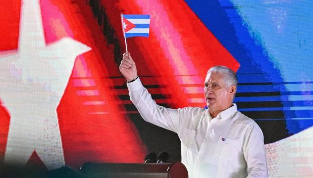 Cuba's President Miguel Díaz-Canel waves a paper flag while delivering a speech during the 73rd anniversary celebration of the guerrilla assault on the Moncada Barracks, led by the late leader Fidel Castro and considered the start of the Cuban Revolution, in Pinar del Rio, Cuba, on July 26, 2026. (Photo by YAMIL LAGE / AFP)
