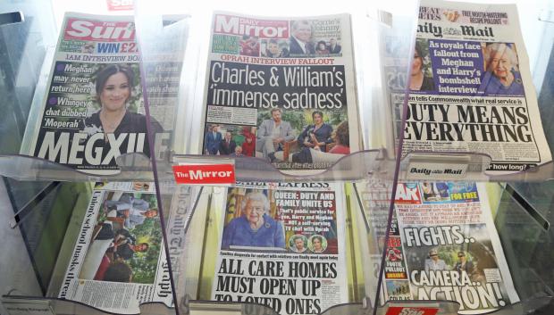 The front pages of newspapers on sale at a garage in Dover, Kent. The Duke and Duchess of Sussex have plunged the monarchy into a crisis, accusing an unnamed royal of racism, suggesting the family were jealous of Meghan and revealing that she contemplated taking her own life while pregnant. Picture date: Monday March 8, 2021. *** Local Caption *** .