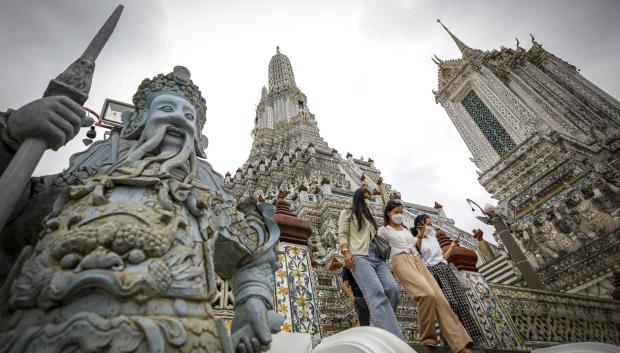 Turistas con mascarilla visitan Wat Arun, el templo de Dawn, este miércoles en Bangkok, Tailandia. Tailandia ha levantado las restricciones de llegada para los viajeros totalmente vacunados que lleguen por vía aérea a partir del 1 de mayo de 2022