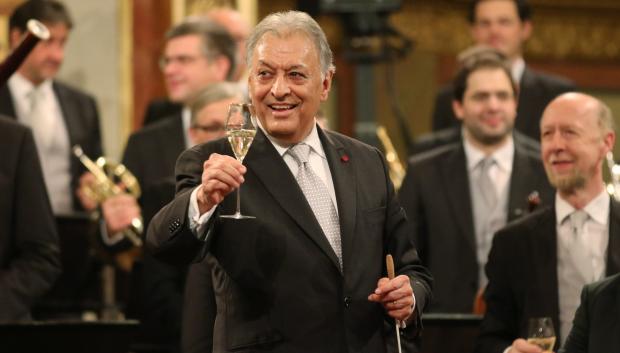 Maestro Zubin Mehta, center, holds a glass of champagne as he conducts the Vienna Philharmonic Orchestra during the traditional New Year's concert at the Musikverein in Vienna, Austria, Thursday, Jan. 1, 2015.
