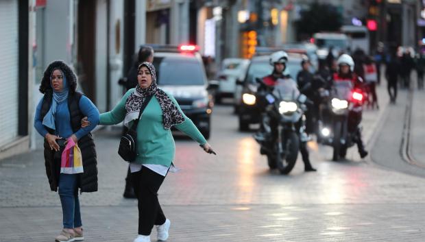 La gente huye mientras los policías turcos intentan asegurar el área después de una explosión en la calle Istiklal, en Estambul