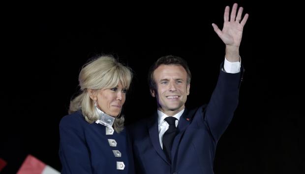 French President Emmanuel Macron and French first lady Brigitte Macron celebrate with supporters during France elecction in Paris, France, Sunday, April 24, 2022.