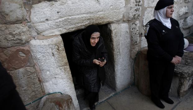 A Christian worshiper walks out of the Church of Nativity, traditionally believed by Christians to be the birthplace of Jesus Christ, in the West Bank town of Bethlehem, Monday, Dec. 24, 2012.