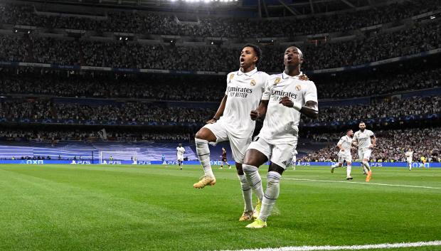 Real Madrid's Brazilian forward Vinicius Junior celebrates with Real Madrid's Brazilian forward Rodrygo (L) scoring his team's first goal during the UEFA Champions League semi-final first leg football match between Real Madrid CF and Manchester City at the Santiago Bernabeu stadium in Madrid on May 9, 2023. (Photo by JAVIER SORIANO / AFP)