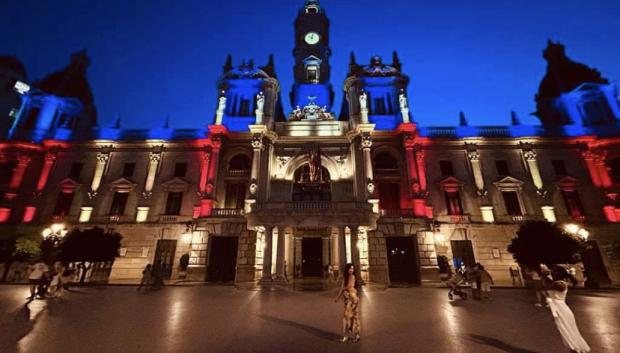 La fachada del Ayuntamiento de Valencia, iluminada con los colores de la Señera regional.