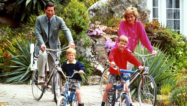 File photo dated 01/06/89 of the Prince and Princess of Wales with sons Prince William, right, and Prince Harry preparing for a cycling trip in Tresco during their holiday on the Scilly Isles. Photos from every year of the King's life have been compiled by the PA news agency, to celebrate Charles III's coronation