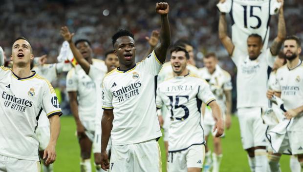 Los jugadores del Madrid celebran la victoria en el césped