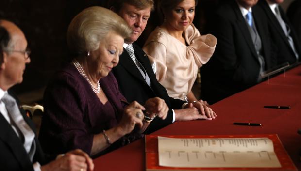 Queen Beatrix signs the Act of Abdication in favour of her son, Prince Willem-Alexander, in the Mozeszaal or Mozes hall of the Royal Palace in Amsterdam, The Netherlands, Tuesday April 30, 2013.