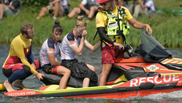 Spain's Carolina Garcia Otero and Sara Ouzande are rescued after capsizing in the women's kayak double 500m final B of the canoe sprint competition at Vaires-sur-Marne Nautical Stadium in Vaires-sur-Marne during the Paris 2024 Olympic Games on August 9, 2024. (Photo by Bertrand GUAY / AFP)