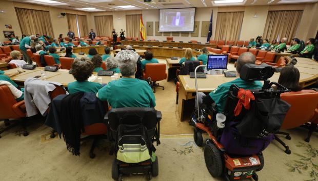 Enfermos de ELA y acompañantes presencian desde una sala contigua el pleno del Congreso de los Diputados que debate la ley ELA este jueves