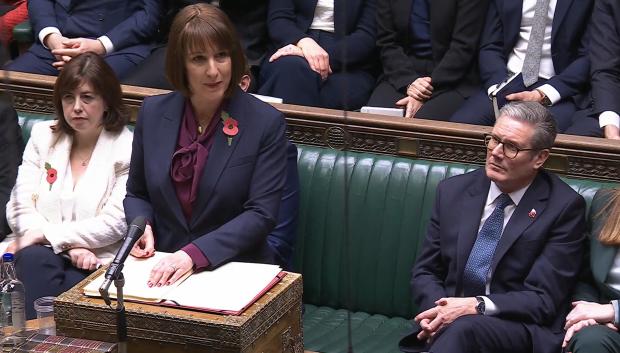 A video grab from footage broadcast by the UK Parliament's Parliamentary Recording Unit (PRU) shows Britain's Prime Minister Keir Starmer (R) listening as Britain's Chancellor of the Exchequer Rachel Reeves delivers her Autumn budget statement in the House of Commons in London on October 30, 2024. (Photo by PRU / AFP) / RESTRICTED TO EDITORIAL USE - MANDATORY CREDIT "AFP PHOTO / PRU " - NO MARKETING - NO ADVERTISING CAMPAIGNS - DISTRIBUTED AS A SERVICE TO CLIENTS