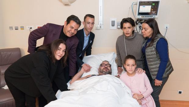 Photo released by the Royal Palace shows Morocco's King Mohammed VI (center) surrounded by his family, L-R : Princess Lalla Hasna, Prince Moulay Rachid, Crown Prince Moulay Hassan (or El Hassan), sisters Princess Lalla Meryem and Lalla Asma, and daughter Lalla Khadija in a hospital in Paris, France on February 26, 2018, after a 'successful operation' related to his heart rythm.