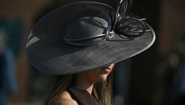 Un aficionado a las carreras con sombrero de ala ancha en la jornada inaugural de la Grand National Festival en el hipódromo de Aintree, Liverpool