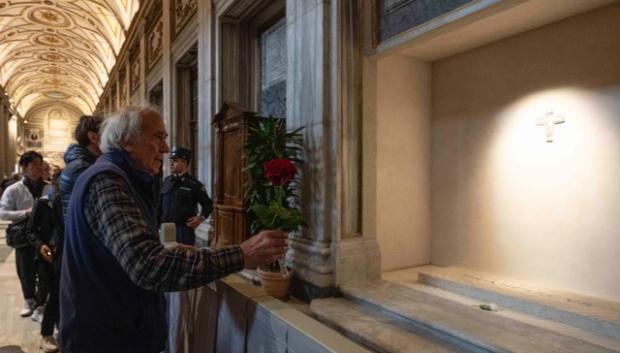 Un hombre lleva una rosa a la tumba del Papa Francisco en la basílica de Santa María la Mayor