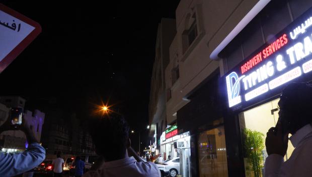 People film projectiles over Doha in Qatar on June 23, 2025. Qatar on June 23, 2025 condemned an Iranian attack on the largest US military base in the region, hosted in the Gulf state, calling it a  "flagrant violation" of its sovereignty". (Photo by AFP)