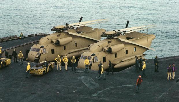Los tripulantes a bordo del portaaviones de propulsión nuclear USS NIMITZ (CVN-68) preparan dos helicópteros RH-53 Sea Stallion para participar en la misión de rescate en Irán.