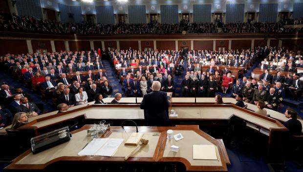 US President Donald Trump shakes hands with members of Congress as he departs following his State of the Union address in the House Chamber of the US Capitol in Washington, DC, on February 24, 2026. (Photo by ANDREW CABALLERO-REYNOLDS / AFP)
