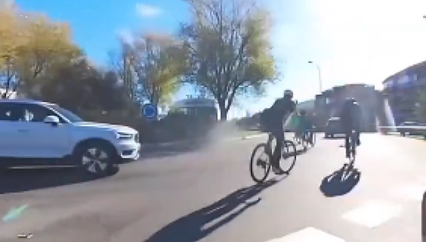 El vehículo en cuestión y el grupo de ciclistas