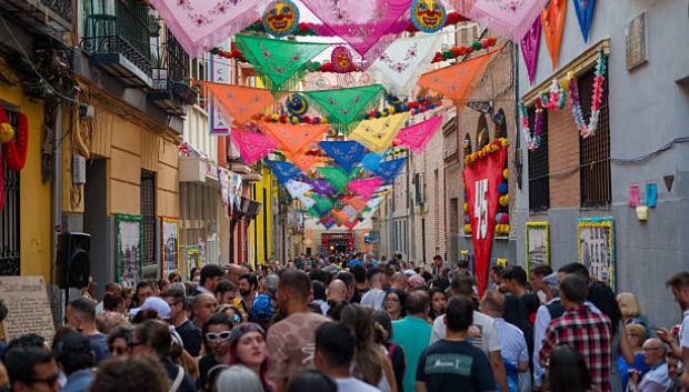 Street decorated with hanging shawls and colorful pennants, city festivitie