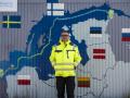 The mayor of Lubmin, Germany, in front of a container decorated with a map showing the Nord Stream 2 gas pipeline