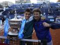 BARCELONA, 24/04/2022.- El tenista español Carlos Alcaraz (i) y su entrenador, Juan Carlos Ferrero, posan con el trofeo del Conde de Godó