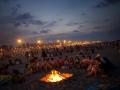 Men and women sit around a fire as they celebrate the San Juan night at a beach in Valencia, Spain, Thursday, June 23, 2011. The San Juan night coincides with the shortest night of the year, and ushers in the start of summer in many cities and towns in Spain