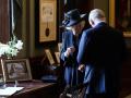 King Charles III and the Queen Consort have trouble signing the guest book at Hillsborough Castle, Northern Ireland