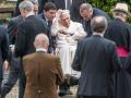 The emeritus Pope Benedict XVI (2nd from left) visits the grave of his parents and sister in a wheelchair at the Ziegetsdorfcemetery near Regensburg.