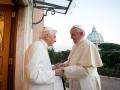 Pope Emeritus Benedict XVI, left, welcomes Pope Francis greetings, at the Vatican, Monday, Dec. 23, 2013.