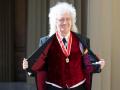 Musician Brian May attending Knighthood at an Investiture ceremony at BuckinghamPalace, London