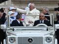 Pope Francis blesses a boy as he arrives in the popemobile car to hold the weekly general audience on April 5, 2023 at St. Peter's square in The Vatican. (Photo by Filippo MONTEFORTE / AFP)