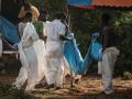 Los trabajadores llevan los cuerpos exhumados en bolsas para cadáveres a la morgue, en Kenia