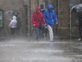 Varias personas con ropa para la lluvia esta mañana en el casco histórico de Santiago de Compostela